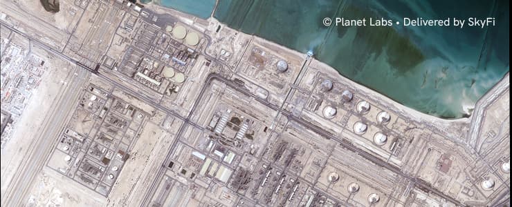 Planet Labs satellite imagery of a coastal industrial site, credited to Planet Labs, delivered by SkyFi